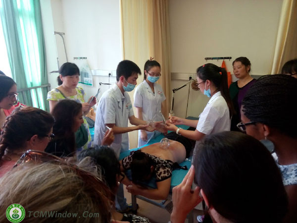a group of our visitors from peru are deeply impressed by the technique of traditional chinese medic