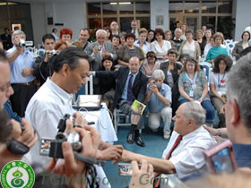 a large medical delegation from europe are watching an acupuncture performance on spot. 